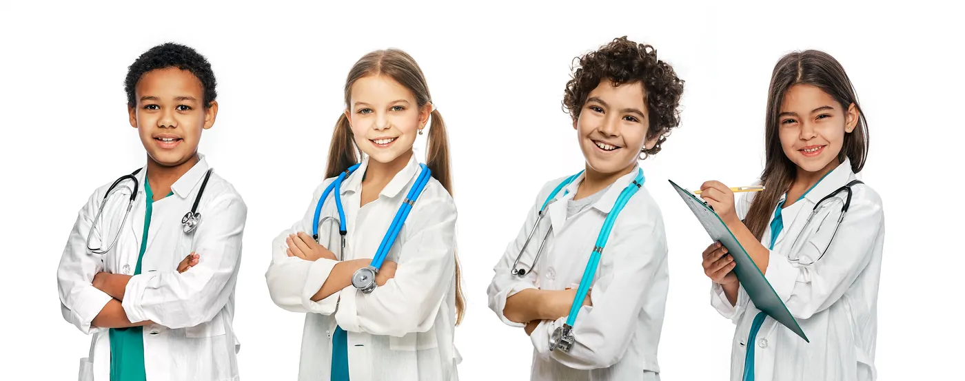 Four children dressed up in white coats with toy stethoscopes