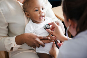 Baby being examined with a stethoscope