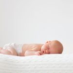 Newborn baby sleeping on their back
