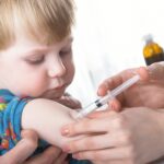 Small boy being vaccinated